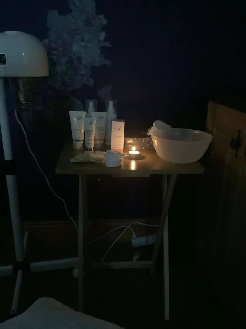 Facial skincare products set out by candlelight