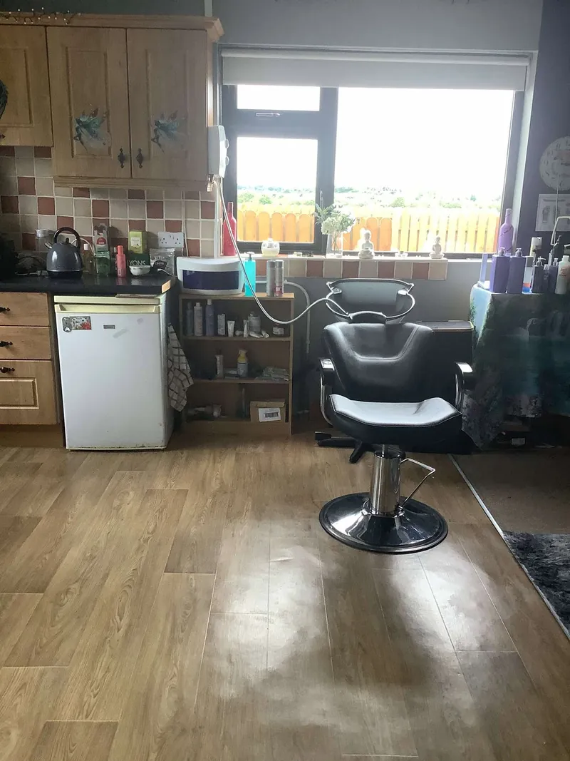 Hair styling chair beside a bright window at A Cut in the Meadows