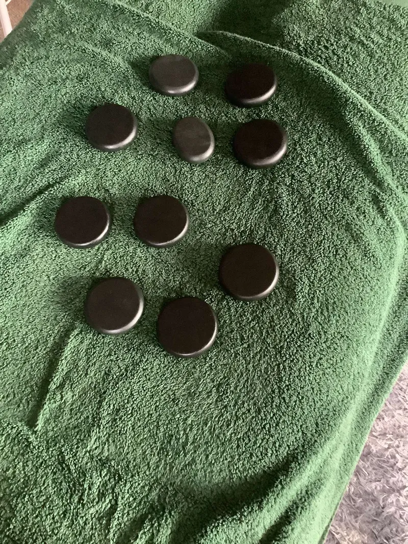 Hot stones laid out on a massage table, ready for a hot stones treatment
